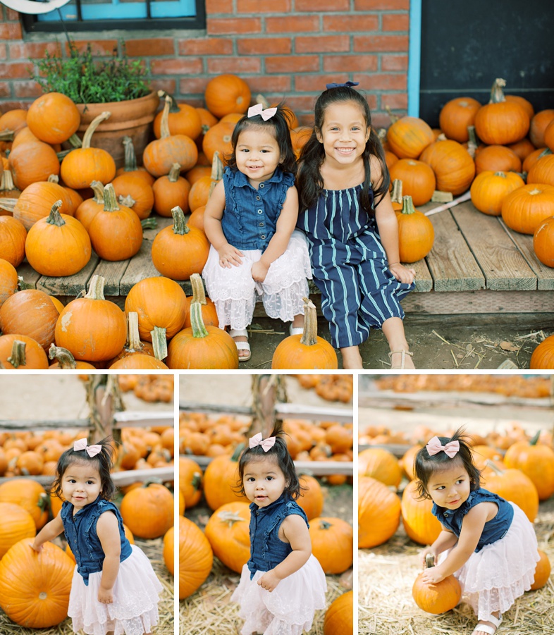 The girls smiling while the pick up different pumpkins.